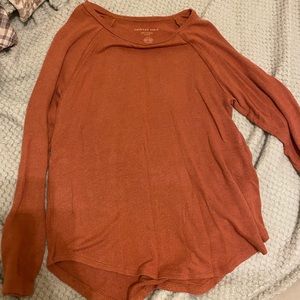 Long sleeve thin sweater.It’s a burnt orange color